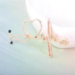Medische broche - elektrocardiogram / stethoscoop / hart - met kristalBroches