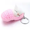 Sleeping cat in a hand-woven cot - keychainKeyrings