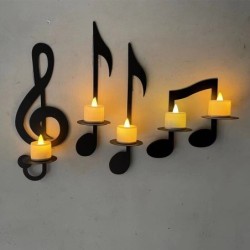 An der Wand befestigter Kerzenhalter - schwarze Musikanmerkungen